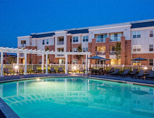 a large swimming pool in front of a building