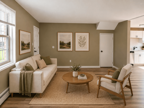 A living room with a couch, chair, and pictures on the wall.