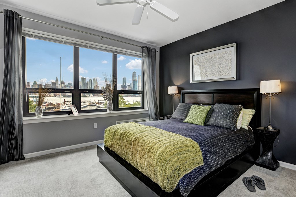 a bedroom with a bed and a view of the city