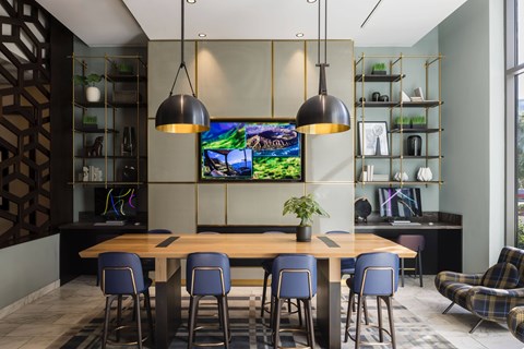A modern dining area with a wooden table and blue chairs.