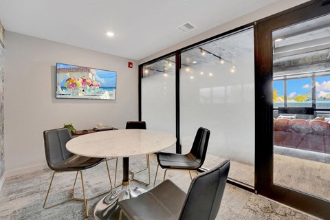 Conference room with round table and frosted glass partition at Bay One Apartments, New Jersey