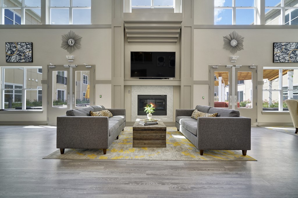 a living room with couches and a table and a fireplace