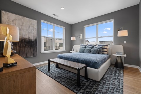 Modern bedroom with gray walls and large windows at Aster Grove Apartments, Warren, New Jersey