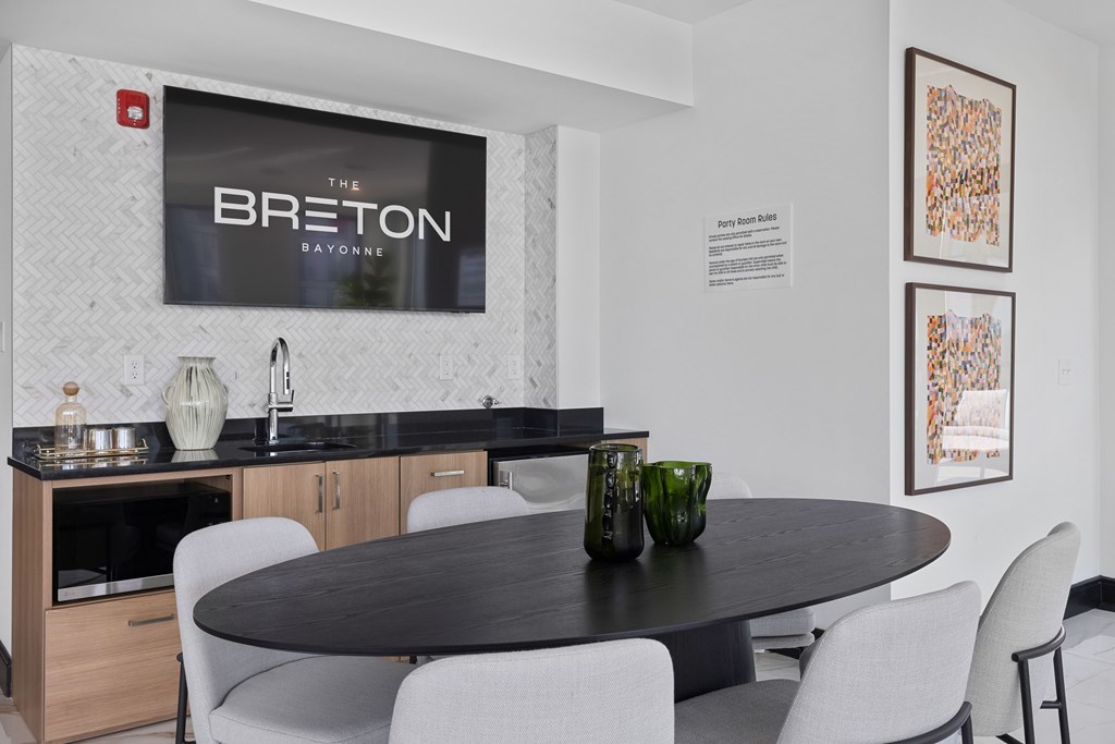 A modern dining room with a Breton Rayonne sign on the wall.