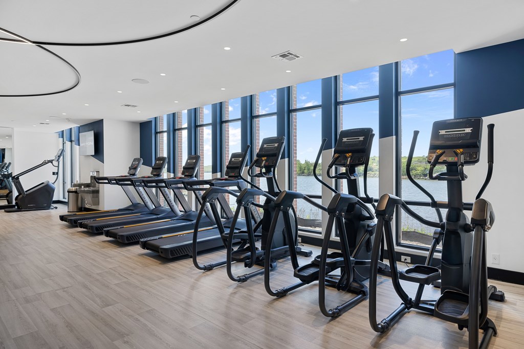 A gym with treadmills and elliptical machines.