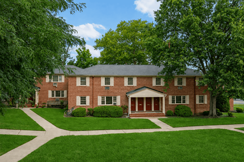 A large red brick house with a white front door.