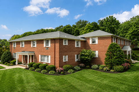 A large red brick house with a white door and windows.
