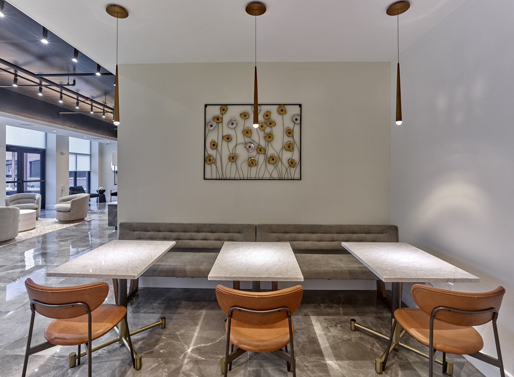 A conference room with a large table and chairs.