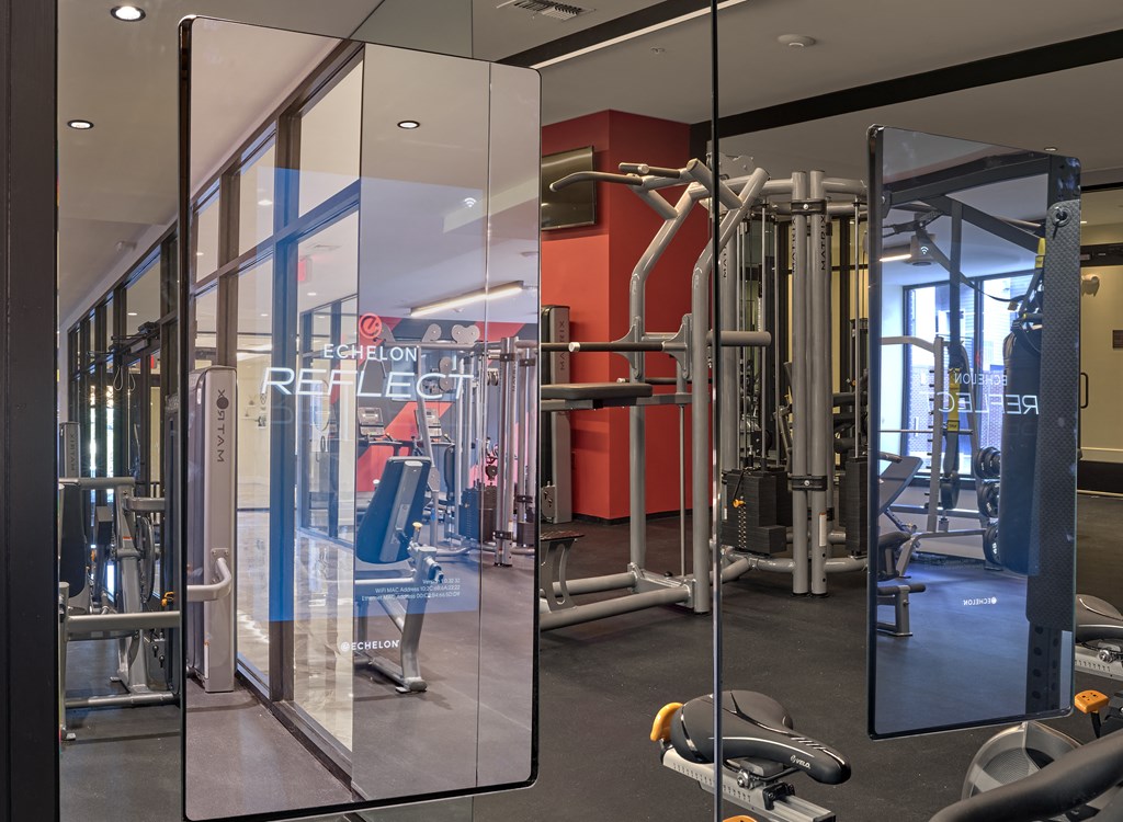 a fitness room with glass walls and exercise equipment