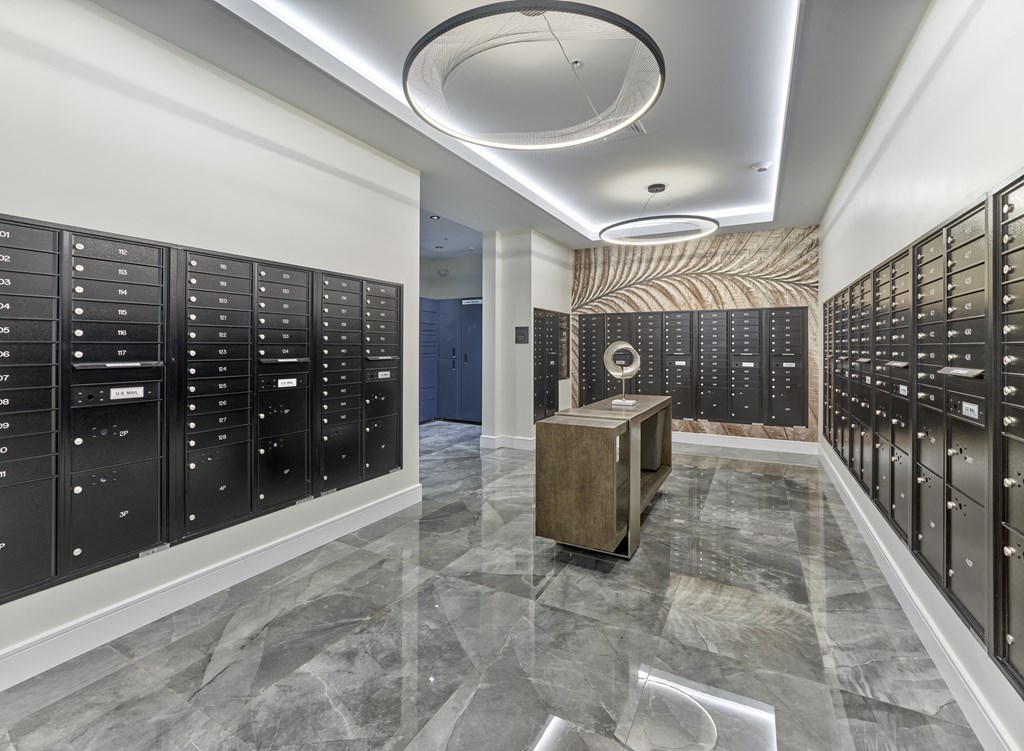 a large locker room with rows of lockers and a table in the middle