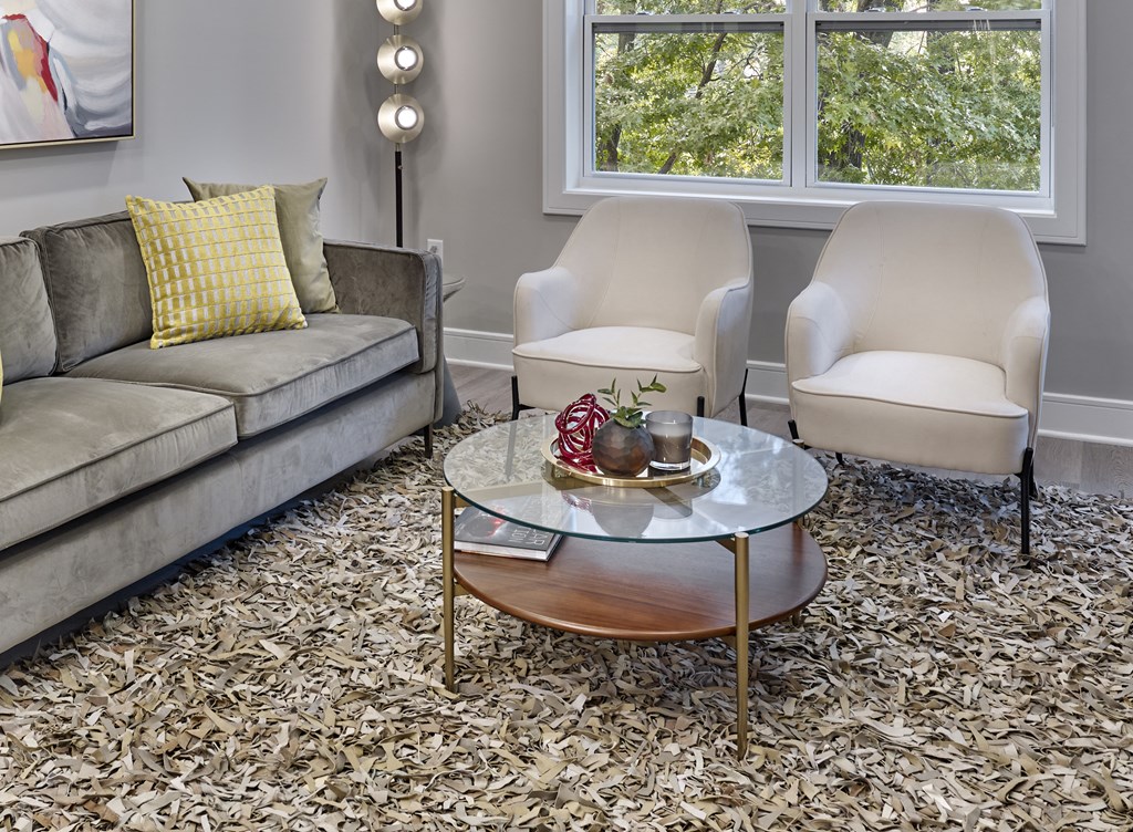 a living room with a couch and chairs and a coffee table