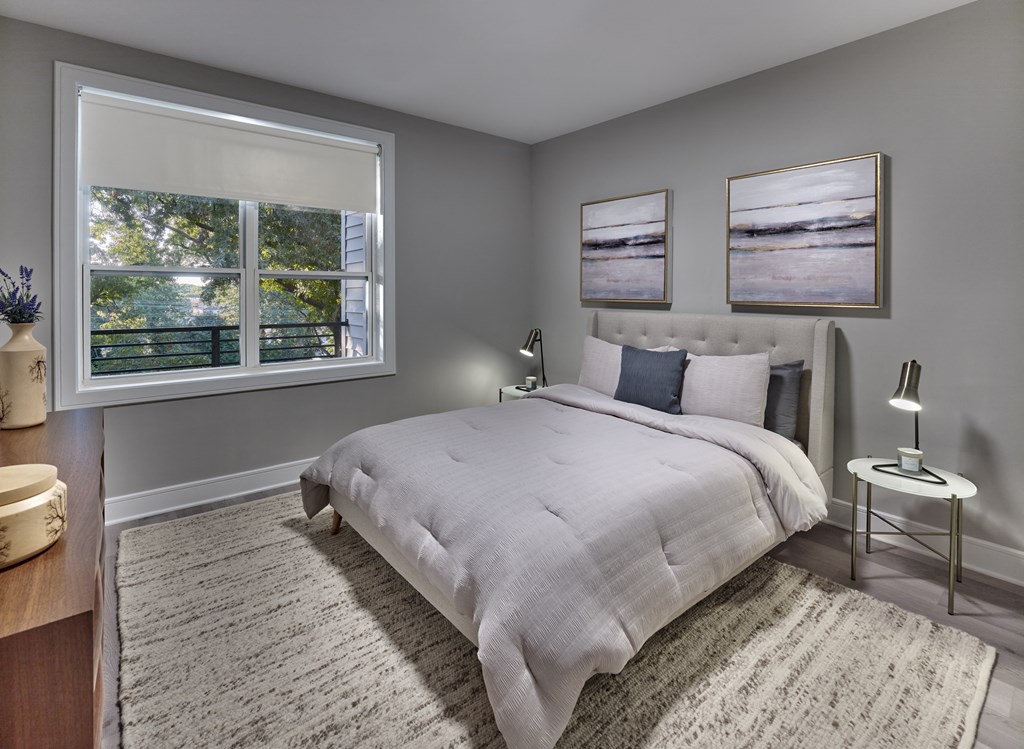 a bedroom with a bed and two windows