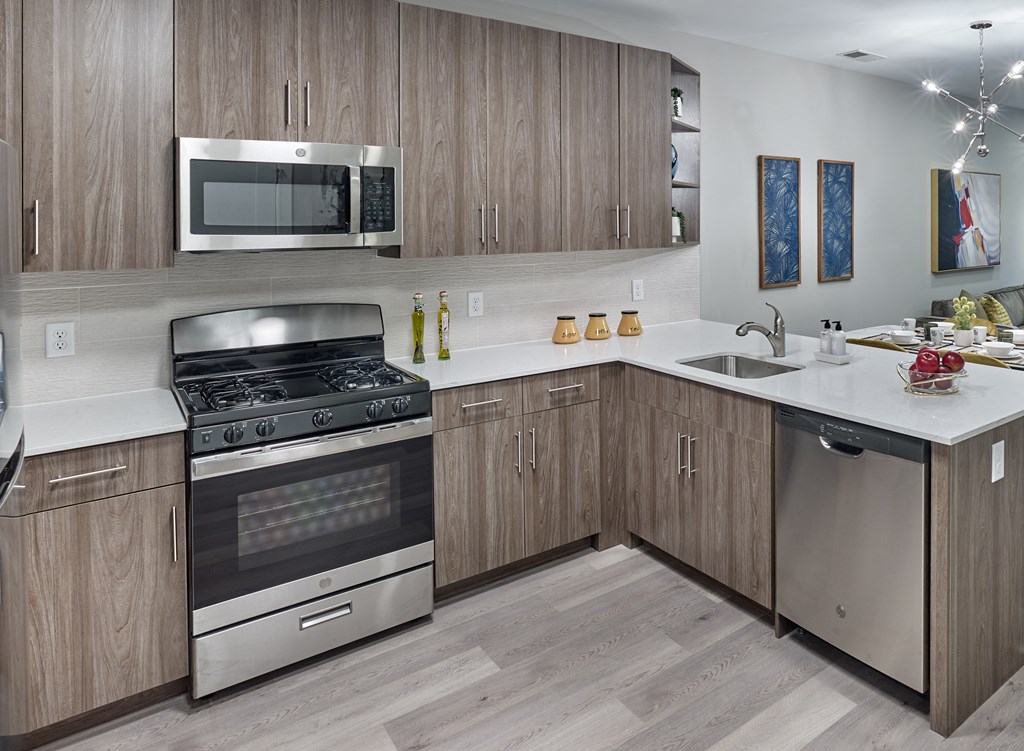 a kitchen with stainless steel appliances and wooden cabinets