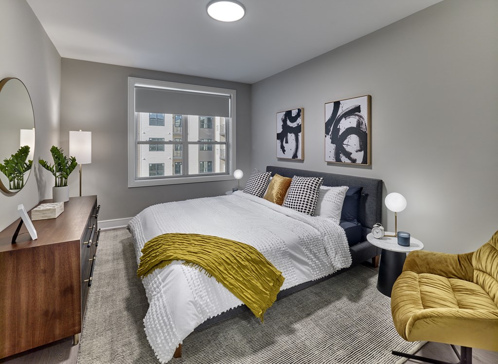 bedroom with white bedspread and pillows and a yellow blanket