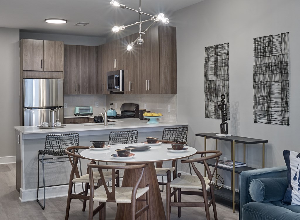 an open kitchen and dining area with a table and chairs