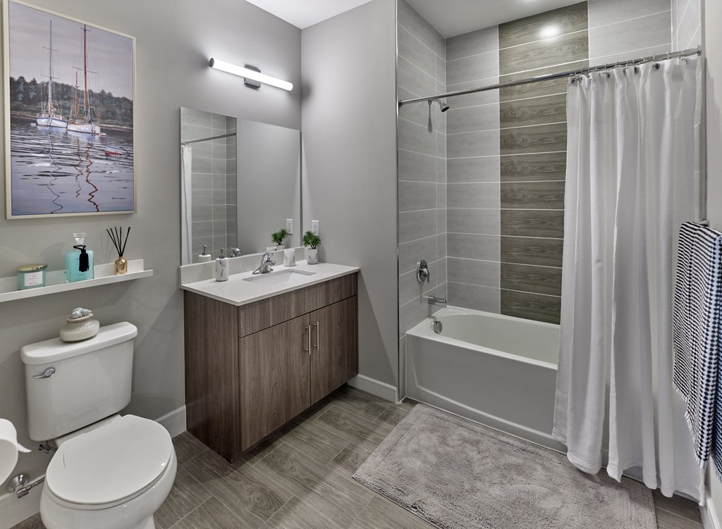 a bathroom with a shower and a toilet and a sink