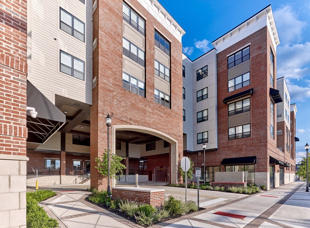 A modern brick building with a clear blue sky in the background.