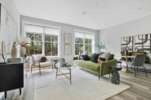 A living room with a green couch and a coffee table.
