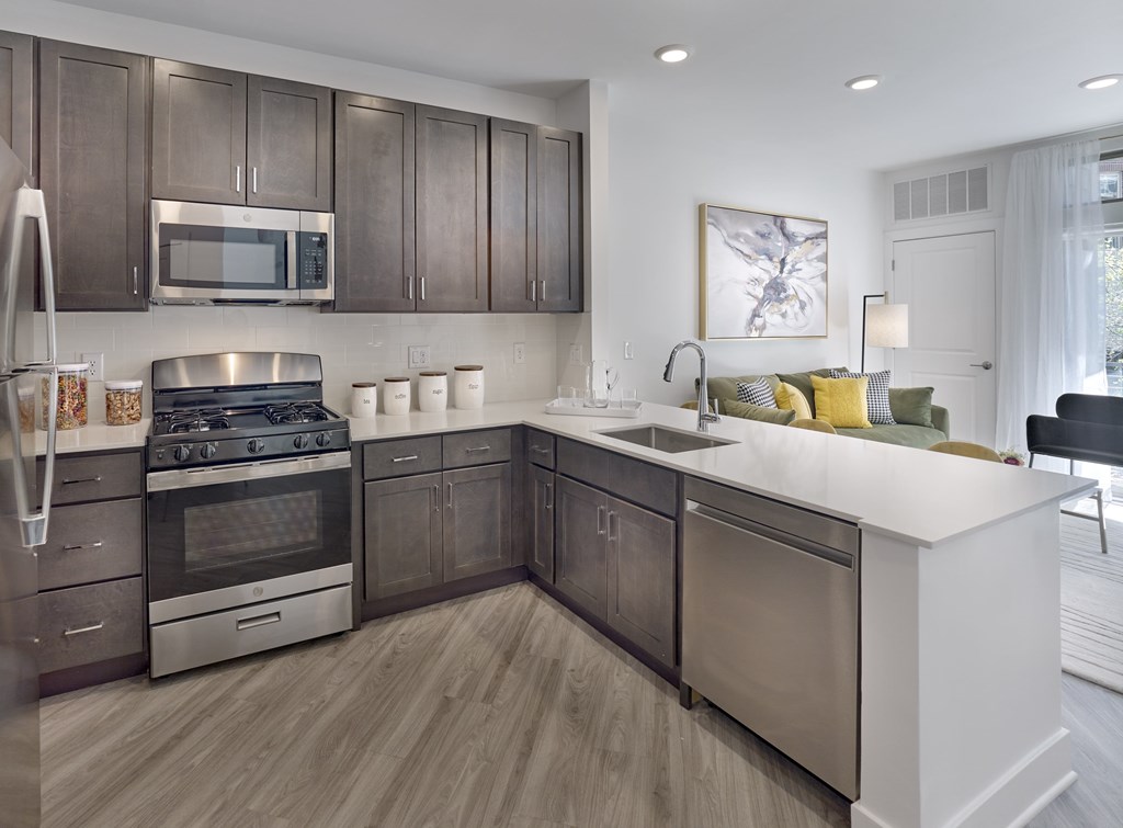 a kitchen with stainless steel appliances and a white counter top