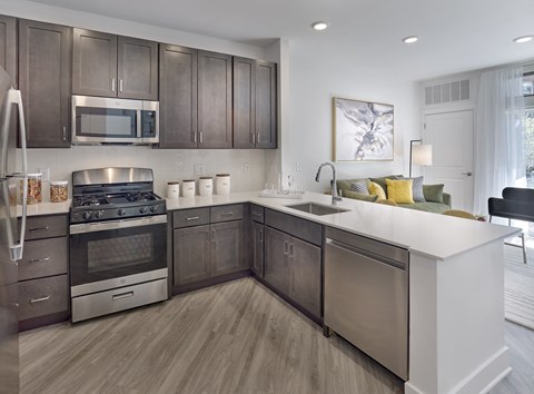 a kitchen with stainless steel appliances and a white counter top