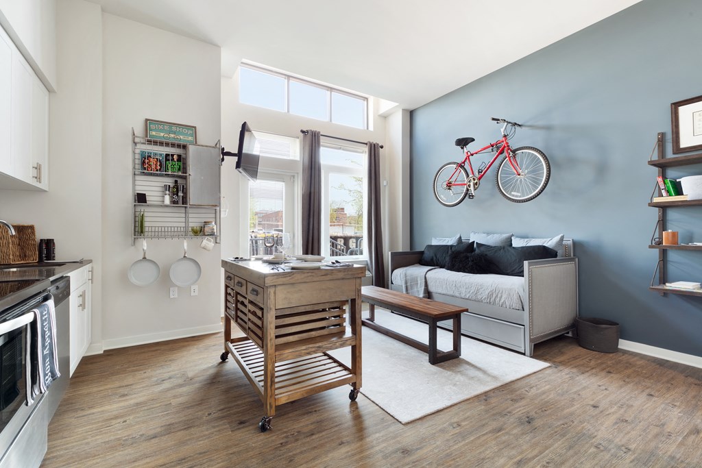 a living room with a couch and a bike hanging on the wall