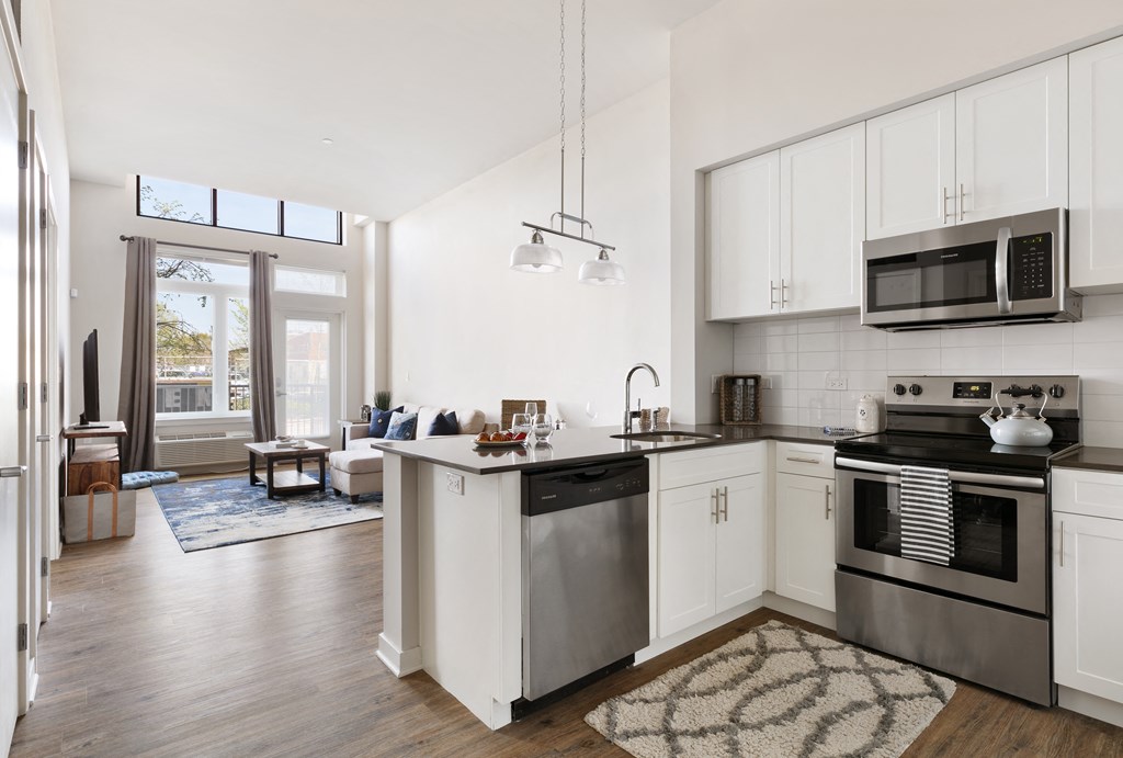 a kitchen with white cabinets and stainless steel appliances