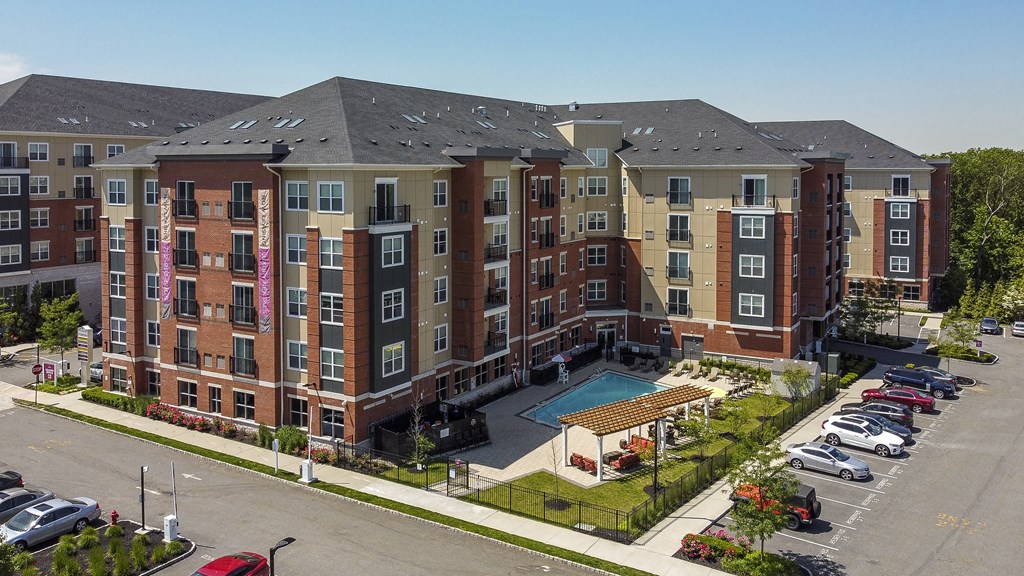 an aerial view of an apartment building with a swimming pool