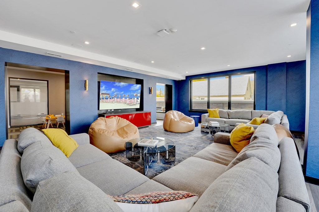 a living room with blue walls and couches and a television