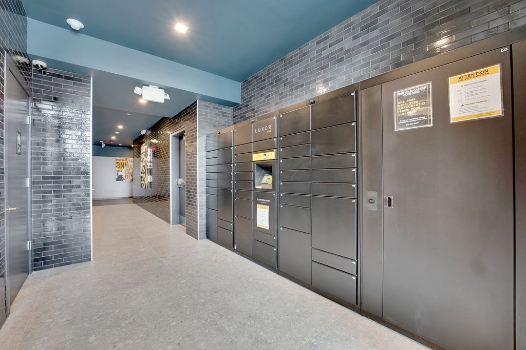 a row of stainless steel lockers in a hallway of a building