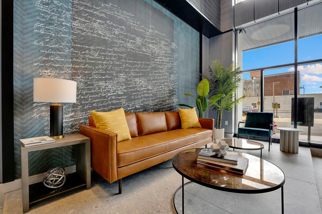 a living room with a leather couch and a table