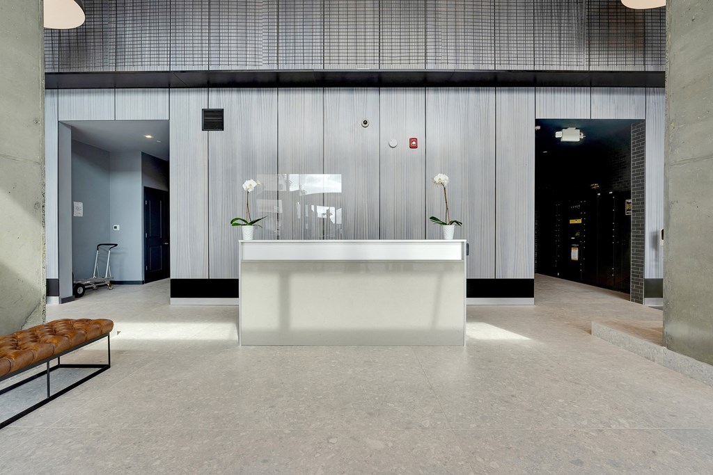 a large lobby with a reception desk and white flowers