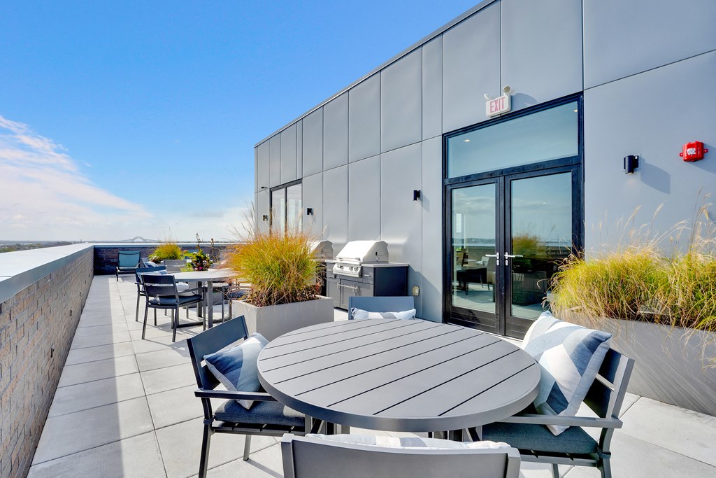 a patio with tables and chairs outside of a building