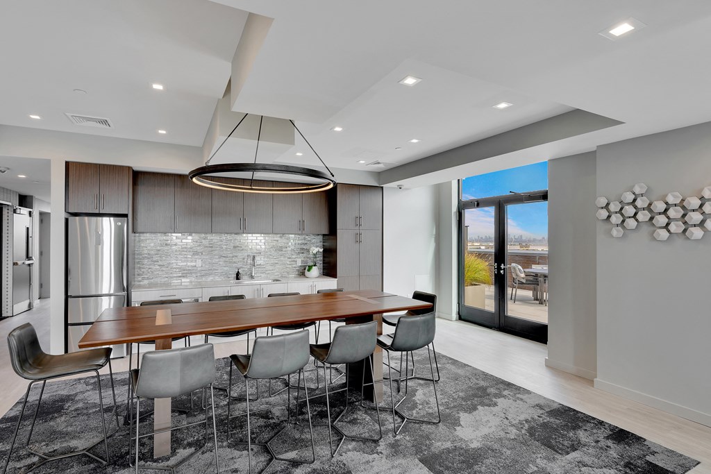a large kitchen with a wooden table and chairs