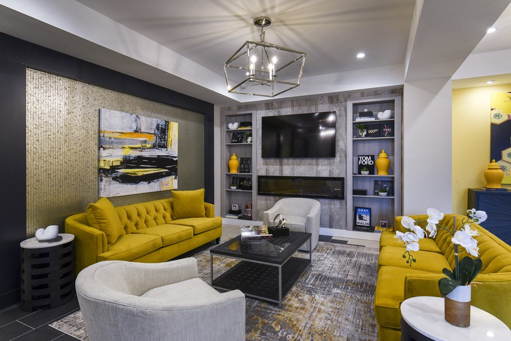 a living room with yellow couches and a television