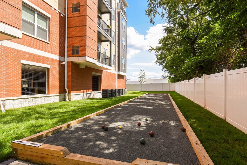 bocce ball court in front of a brick building