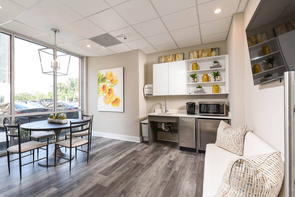 a living room and kitchen with a table and chairs