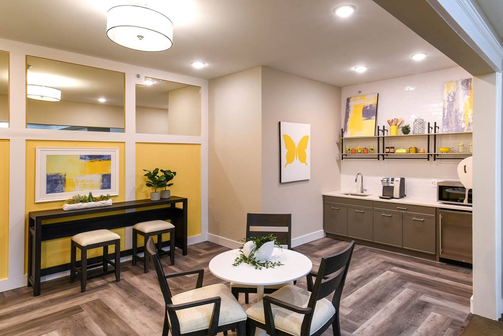 a dining room with a table and chairs and a kitchen