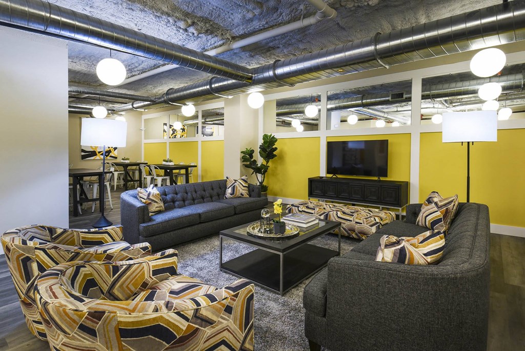 a living room with couches and chairs and a television