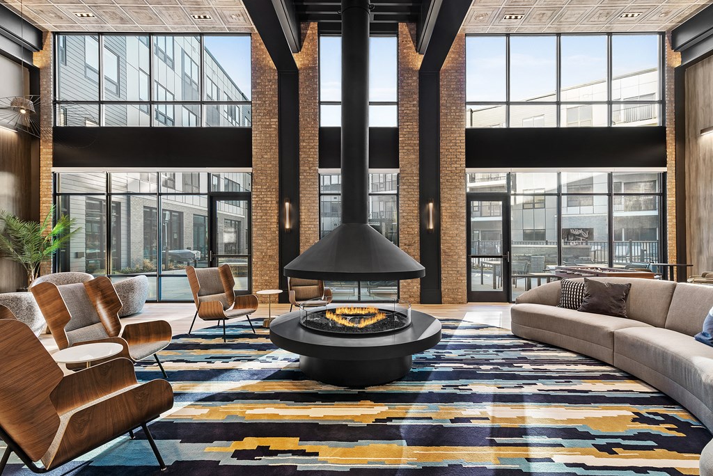 a living room with a fireplace and large windows