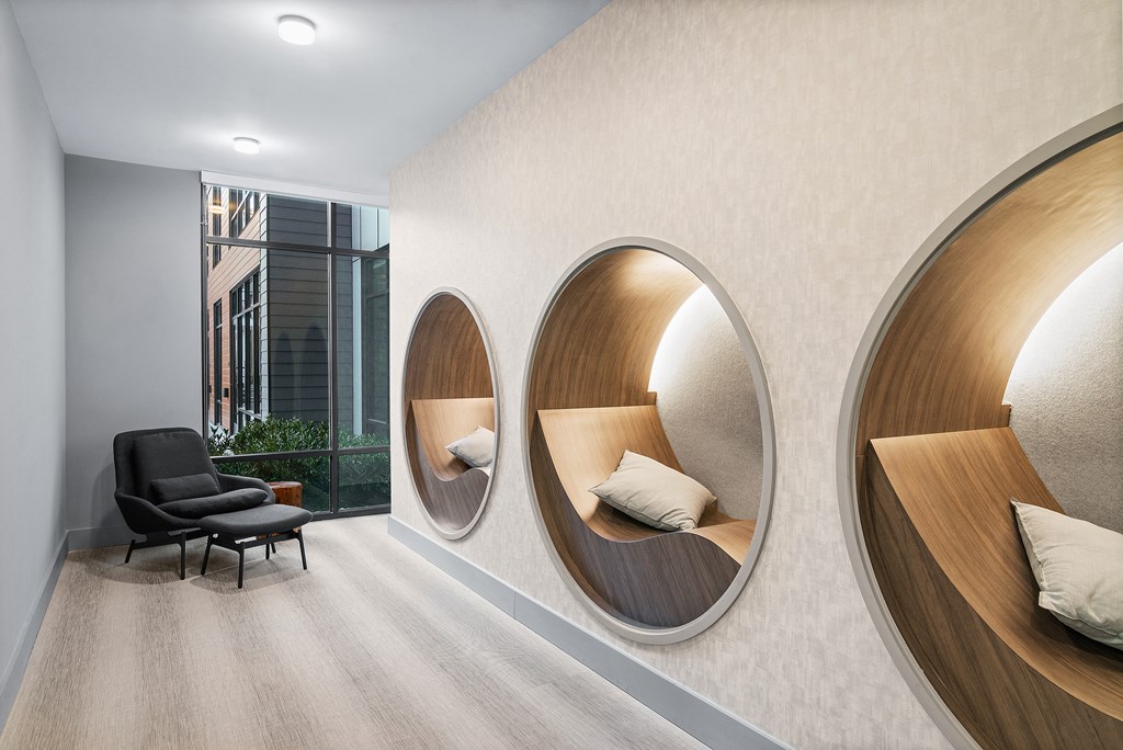 a room with three round mirrors on the wall and a chair