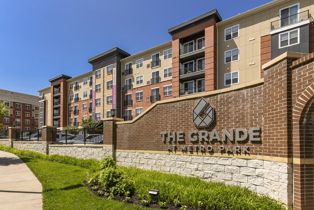 a brick building with the grande metro park sign in front of it