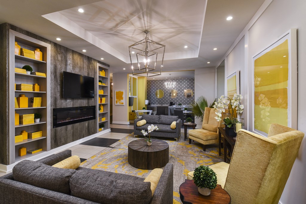 a living room with couches and chairs and a television