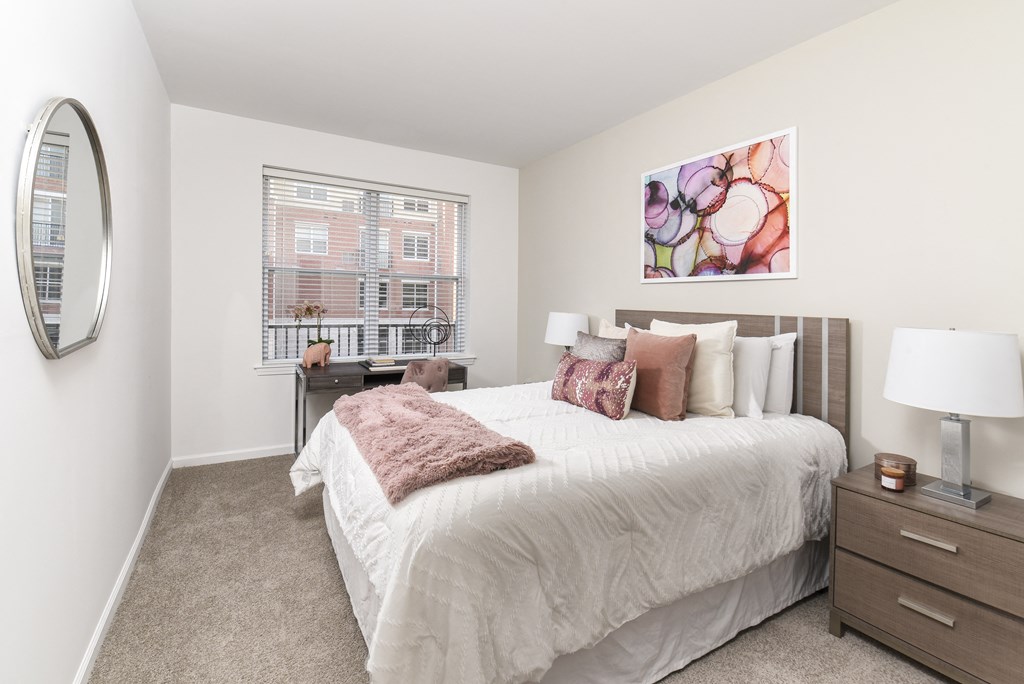 a bedroom with a large bed and a window