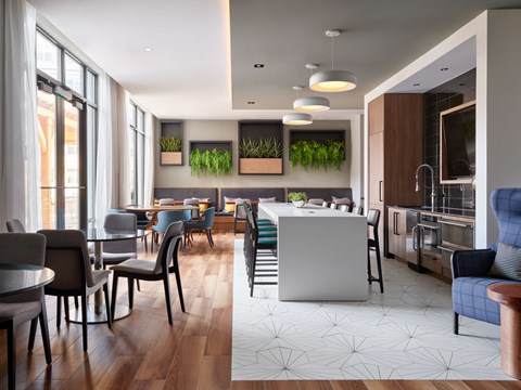 A modern kitchen and dining area with wooden floors and contemporary furniture.