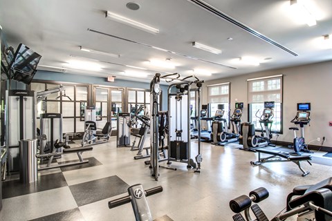 Fitness center with cardio machines and strength training equipment at Highlands at Hilltop Apartments, Verona, 07044
