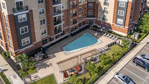 An aerial view of a pool surrounded by apartment buildings.