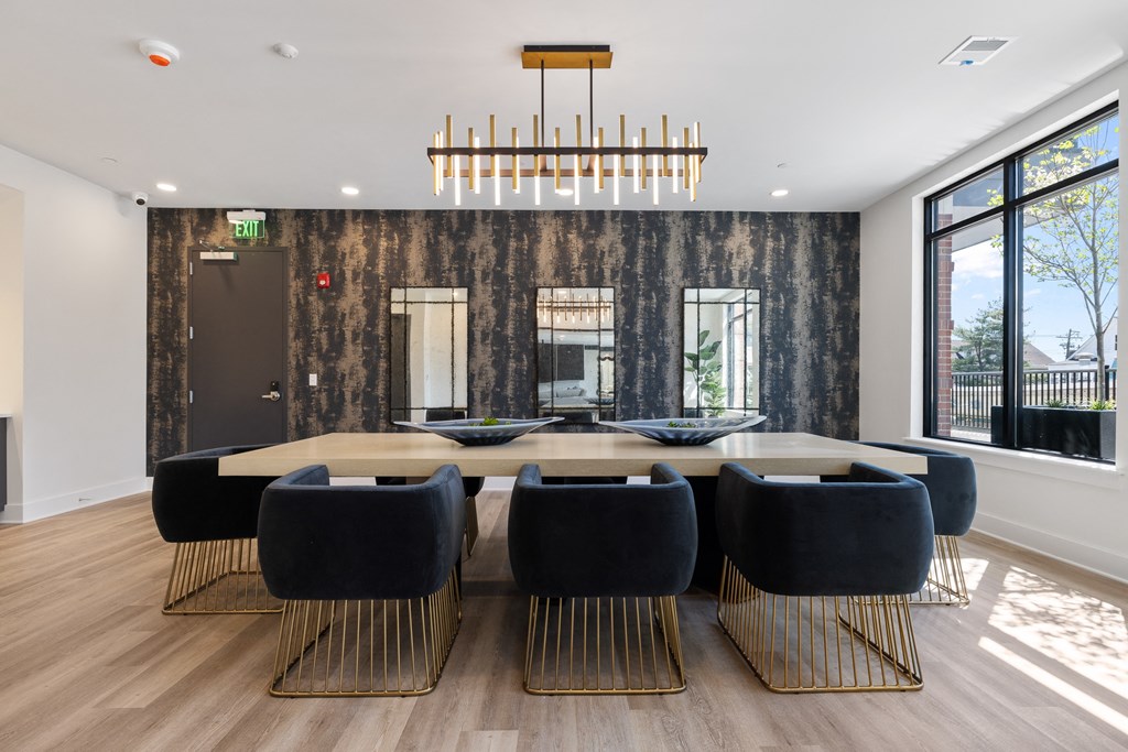 a dining room with a large table and chairs and a large window