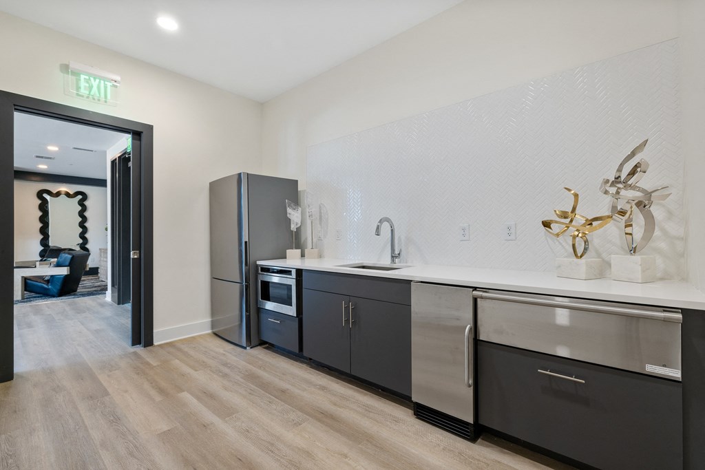 a kitchen with two sinks and a door to a living room
