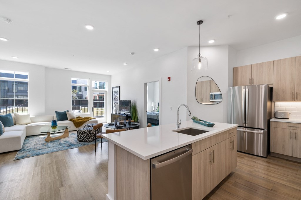 a kitchen with a large island and a living room