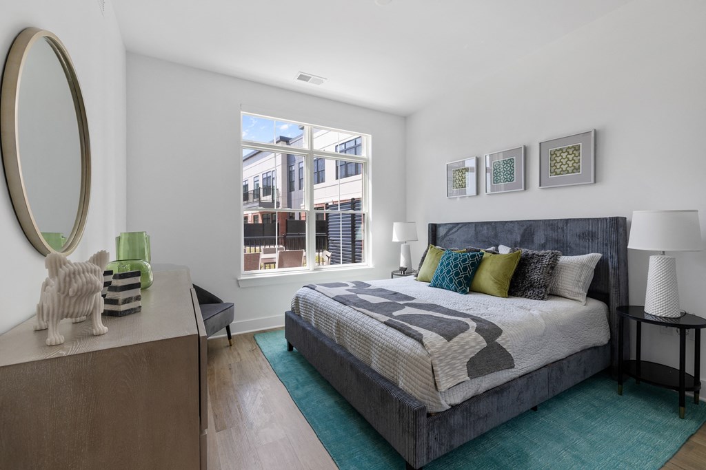 a bedroom with a bed and a large window
